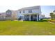 Well-maintained backyard, with a patio, screened-in porch, lush lawn, and green landscaping at 408 Trevi Ln, Summerville, SC 29486