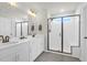 Modern bathroom with double sink vanity, large mirror, and glass enclosed shower with bench seating at 408 Trevi Ln, Summerville, SC 29486