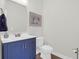 Charming powder room featuring a modern vanity with a white sink and artistic floral wall art at 408 Trevi Ln, Summerville, SC 29486