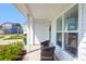 Close-up of a cozy front porch featuring outdoor seating and a view of the neighborhood at 408 Trevi Ln, Summerville, SC 29486