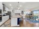 Bright, modern kitchen boasting stainless steel appliances and hardwood floors leading to the dining area at 408 Trevi Ln, Summerville, SC 29486