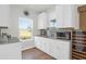 Bright kitchenette features white cabinetry, a beverage cooler, stainless steel appliances, and views to the outside at 408 Trevi Ln, Summerville, SC 29486