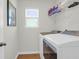 Functional laundry room with modern washer and dryer, shelving, and a bright window at 408 Trevi Ln, Summerville, SC 29486