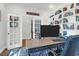 Well-lit home office with built-in bookshelves, a spacious desk, and double doors leading to the foyer at 408 Trevi Ln, Summerville, SC 29486