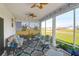 Inviting screened porch featuring comfortable seating, ceiling fans, and picturesque views of the surrounding community at 408 Trevi Ln, Summerville, SC 29486