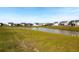 Community pond surrounded by lush green lawns and neighboring homes, creating a peaceful environment at 408 Trevi Ln, Summerville, SC 29486