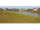 Beautiful pond surrounded by green grass, offering serene views of the surrounding neighborhood at 408 Trevi Ln, Summerville, SC 29486