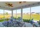 Relaxing screened porch with a ceiling fan, seating area, and scenic backyard views at 408 Trevi Ln, Summerville, SC 29486