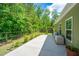 Backyard featuring a covered patio, stone patio, a privacy fence, and green vinyl siding at 409 Carousel Ct, Summerville, SC 29483