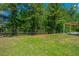 Large backyard with grass and privacy fence backing up to a wooded area at 409 Carousel Ct, Summerville, SC 29483