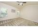 Bright, airy bedroom with neutral walls, soft carpet, and ample natural light pouring in from two windows at 409 Carousel Ct, Summerville, SC 29483