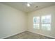 Bright bedroom with neutral carpet, a ceiling fan, and large windows showcasing neighborhood views at 409 Carousel Ct, Summerville, SC 29483