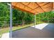 Large covered patio, great for entertaining, with a view of the green, tree-lined backyard at 409 Carousel Ct, Summerville, SC 29483