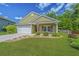 Charming single-story home featuring a well-maintained lawn and a welcoming two-car garage at 409 Carousel Ct, Summerville, SC 29483