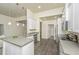 Modern kitchen featuring an island with a sink, white cabinets and stainless steel appliances at 409 Carousel Ct, Summerville, SC 29483