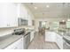 Well-lit kitchen featuring stainless steel appliances, gray countertops, and white cabinetry with modern finishes at 409 Carousel Ct, Summerville, SC 29483