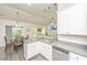 Bright kitchen showcasing white cabinets, stainless steel appliances, and a view of the dining and living area at 409 Carousel Ct, Summerville, SC 29483