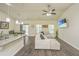 Bright living area with a fan, adjacent to the dining area and open to the kitchen at 409 Carousel Ct, Summerville, SC 29483
