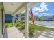 Charming neighborhood view from the front porch with American flag and manicured landscaping at 409 Carousel Ct, Summerville, SC 29483