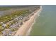 Beautiful aerial view of homes along the shore with waves and sandy beach at 412 Palmetto Blvd, Edisto Island, SC 29438