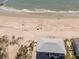 Aerial view of a charming blue beach house near the ocean and sandy shores at 412 Palmetto Blvd, Edisto Island, SC 29438