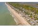 Stunning aerial view showcasing beachfront homes along a picturesque coastline with lush greenery and tranquil waters at 412 Palmetto Blvd, Edisto Island, SC 29438