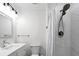 Well-lit bathroom featuring marble tile, a shower with curtain, and modern fixtures at 412 Palmetto Blvd, Edisto Island, SC 29438
