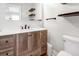 Stylish bathroom with a wood vanity, open shelving, and a toilet at 412 Palmetto Blvd, Edisto Island, SC 29438