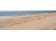 Expansive beach landscape with soft sand and footprints leading to the ocean waves at 412 Palmetto Blvd, Edisto Island, SC 29438