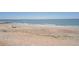Scenic beach view with gentle waves and clear skies, inviting for relaxation and recreation at 412 Palmetto Blvd, Edisto Island, SC 29438