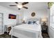 Bright bedroom with a white bed, stylish coastal decor, and flat screen TV at 412 Palmetto Blvd, Edisto Island, SC 29438