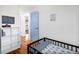 Cozy bedroom features a crib, shelving unit, and light blue door, perfect for a young  at 412 Palmetto Blvd, Edisto Island, SC 29438