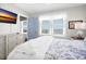 Bright bedroom featuring ocean views from the windows, a TV, and a blue and white color scheme at 412 Palmetto Blvd, Edisto Island, SC 29438