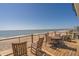 Oceanfront deck with outdoor seating for enjoying panoramic views of the beach and the sea at 412 Palmetto Blvd, Edisto Island, SC 29438