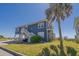 Charming blue beach home featuring elevated construction, a yard and ample space underneath at 412 Palmetto Blvd, Edisto Island, SC 29438