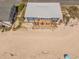 Aerial view of beach house featuring a deck with outdoor seating and direct beach access at 412 Palmetto Blvd, Edisto Island, SC 29438