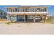 Charming beach house with elevated deck, perfect for enjoying ocean views and coastal living at 412 Palmetto Blvd, Edisto Island, SC 29438