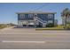 Inviting beach house with covered parking, stairs, and easy access to the beach at 412 Palmetto Blvd, Edisto Island, SC 29438