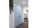 Hallway with wood-look floors, leading to a kitchen visible through an open doorway at 412 Palmetto Blvd, Edisto Island, SC 29438