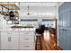 Modern kitchen with white cabinets, stainless steel appliances, and a breakfast bar that opens to the dining area at 412 Palmetto Blvd, Edisto Island, SC 29438