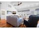 Bright living room with hardwood floors, cozy seating, and an ocean view through the many windows at 412 Palmetto Blvd, Edisto Island, SC 29438