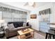 Comfortable living room with a sofa, accent pillows, TV, and a quaint blue door at 412 Palmetto Blvd, Edisto Island, SC 29438