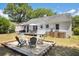 Expansive backyard featuring a cozy firepit area with multiple chairs and lush landscaping at 4503 Overbrook Ave, North Charleston, SC 29405