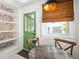 Bright breakfast nook with green door, stylish wallpaper and a round wood table at 4503 Overbrook Ave, North Charleston, SC 29405