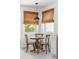 Charming breakfast nook with a round wood table, woven blinds, and a pendant light at 4503 Overbrook Ave, North Charleston, SC 29405