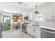 Eat-in kitchen featuring stainless appliances, bright white cabinets, and a charming green door at 4503 Overbrook Ave, North Charleston, SC 29405