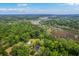 Extensive aerial view captures the home's location amidst the trees, waterways, and a sprawling landscape at 4942 Storage Rd, Meggett, SC 29449