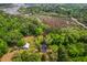 Beautiful aerial view of a home surrounded by lush greenery and meandering waterways under a clear blue sky at 4942 Storage Rd, Meggett, SC 29449