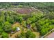 Stunning aerial perspective of a charming home nestled amidst verdant greenery and natural beauty at 4942 Storage Rd, Meggett, SC 29449