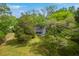 Aerial view of a home nestled among lush green trees, showcasing its serene and private setting at 4942 Storage Rd, Meggett, SC 29449